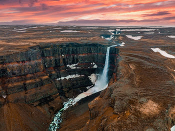 Aerial view on hengifoss waterfall with red stripes sediments in iceland.