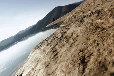 Scenic view of sand dunes against sky