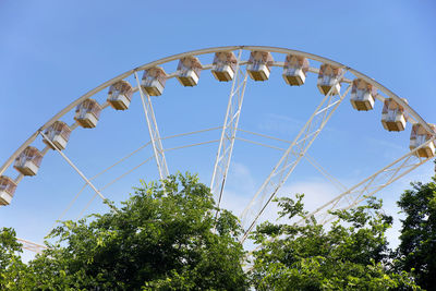 Low angle view of ferris wheel against clear blue sky