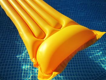 High angle view of yellow inflatable raft on swimming pool