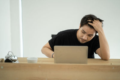 Portrait of man sitting on table