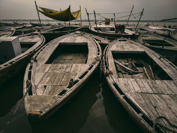 Boats moored in river against sky