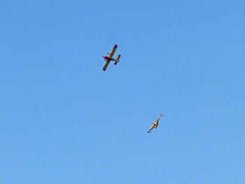 Low angle view of helicopter flying in sky