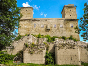 Low angle view of historical building against blue sky