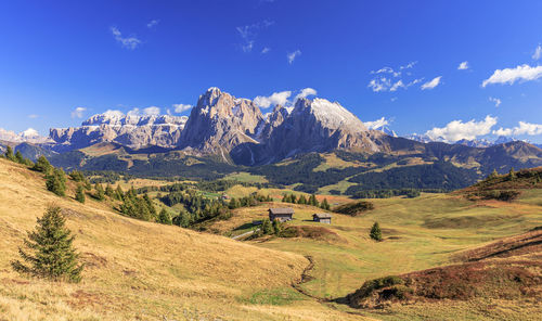 Scenic view of snowcapped mountains against blue sky