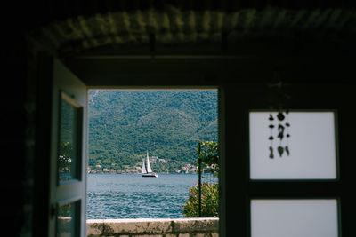 View of sailboat seen through window