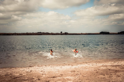 People on beach against sky