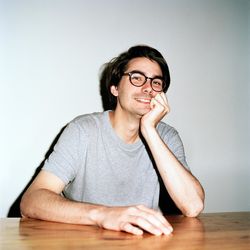 Portrait of young man sitting on table