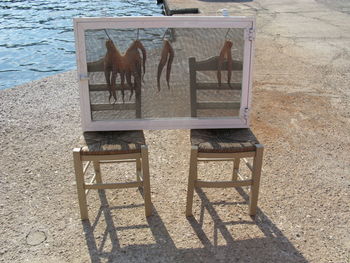 High angle view of chairs on table at beach