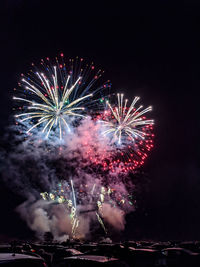 Low angle view of firework display at night