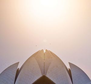 Low angle view of modern building against sky during sunset