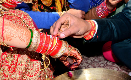 The bride and groom playing find the ring game in north indian wedding / marriage ceremony