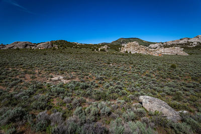 Scenic view of rocky mountains against clear blue sky