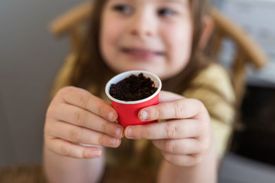 Midsection of woman holding coffee