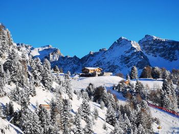 Scenic view of snowcapped mountains against clear blue sky