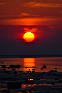 Scenic view of sea against romantic sky at sunset