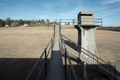 Empty road on field against sky