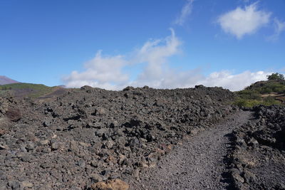 Panoramic view of arid landscape against blue sky