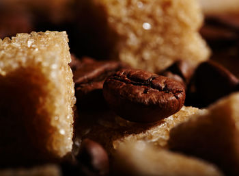 Detail shot of sugar cubes on coffee beans