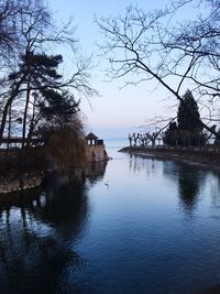 Scenic view of lake against sky at sunset