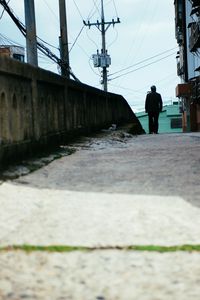 Man on road against sky