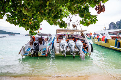 People on boat in river against sky