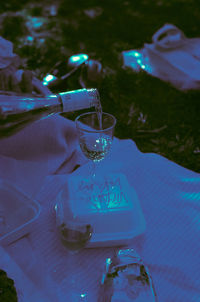 Close-up of hand pouring wine glass on table