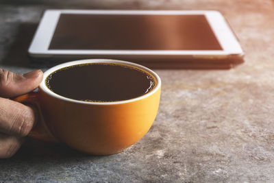 Person holding coffee cup