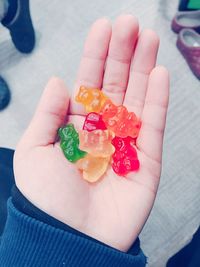 Cropped hand holding colorful gummi bears