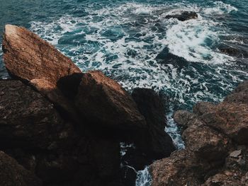 High angle view of rocks at sea shore