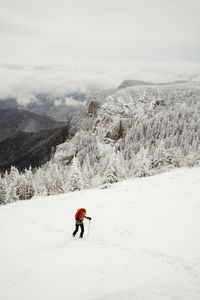 Man skiing on snow covered mountain