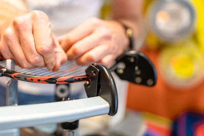 Cropped hand of man repairing machinery