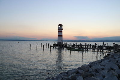 Pier on sea at sunset