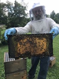 Close-up of a man with umbrella against plants