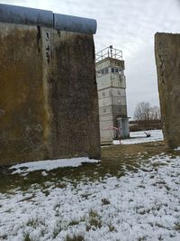 Snow covered field by building