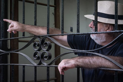 Man holding metal grate in building