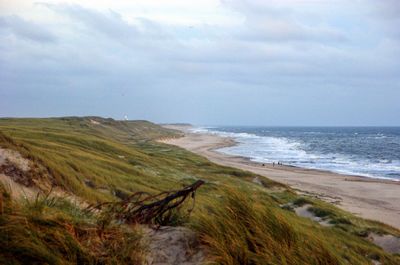 Scenic view of sea against cloudy sky