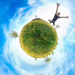 Fish-eye view of man jumping on grassy field