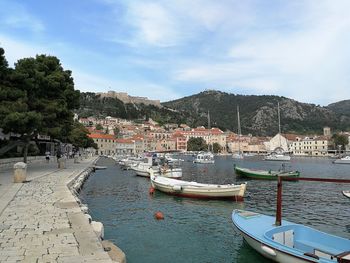 Boats moored in hvar harbour against sky