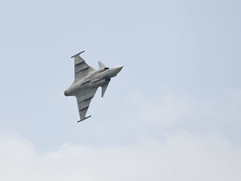 Low angle view of airplane flying against sky