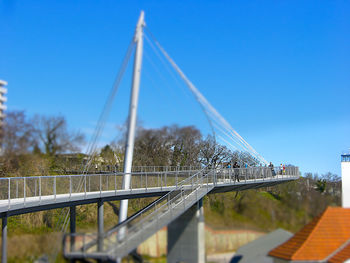 Suspension bridge against blue sky