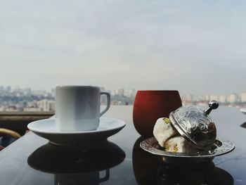 Close-up of food and drink on table against sky