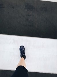 Close-up of person standing on tiled floor