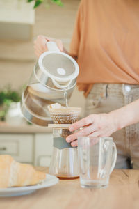 Midsection of woman preparing food on table