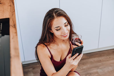 Young woman using mobile phone outdoors