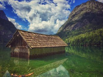 Built structure by lake against sky