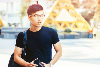 Asian young boy with fashion street style in saigon city, vietnam