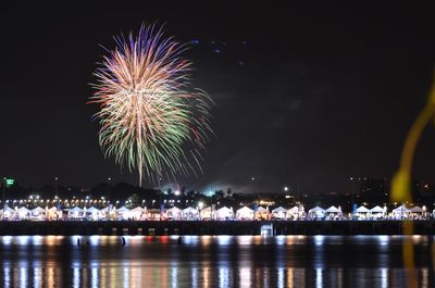 Firework display against sky at night