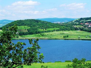 Scenic view of lake against cloudy sky