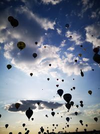 Low angle view of hot air balloons flying in sky